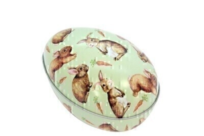 Easter Egg Tin Container With Bunnies by Gisela Graham Easter egg tin container with bunnies and carrot design.  Tin can be opened and can be filled with goodies for Easter. This Easter bunny egg comes from designer Gisela Graham who makes unique Easter gifts.  Size 8.5cm x 12.5cm x 9cm